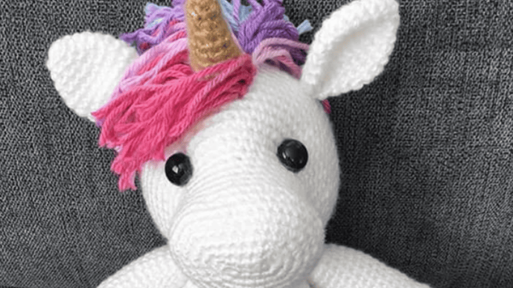 white unicorn with pink hair and horn
