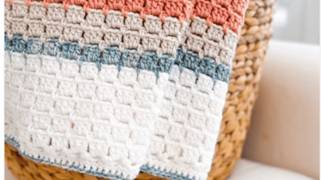 white blue, tan and peach crochet blanket
