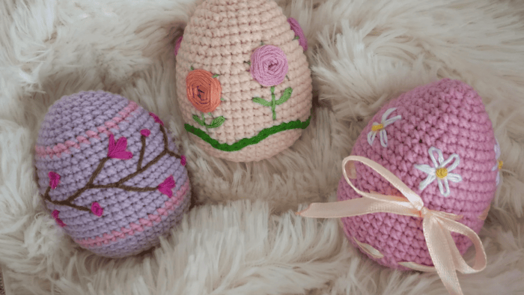 3 Easter eggs purple, cream and pink with embroidery flowers on them. Cute Crochet Easter egg patterns