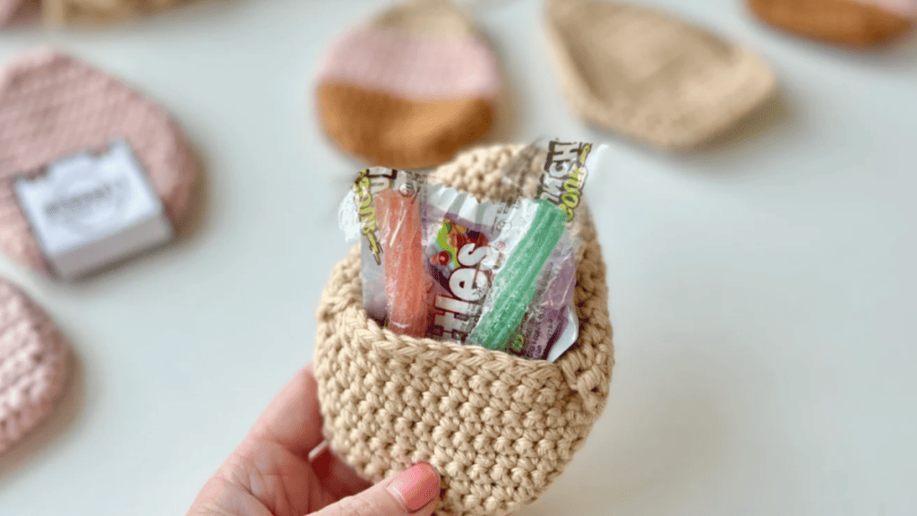 refillable crochet easter egg in tan yarn with candy in the egg