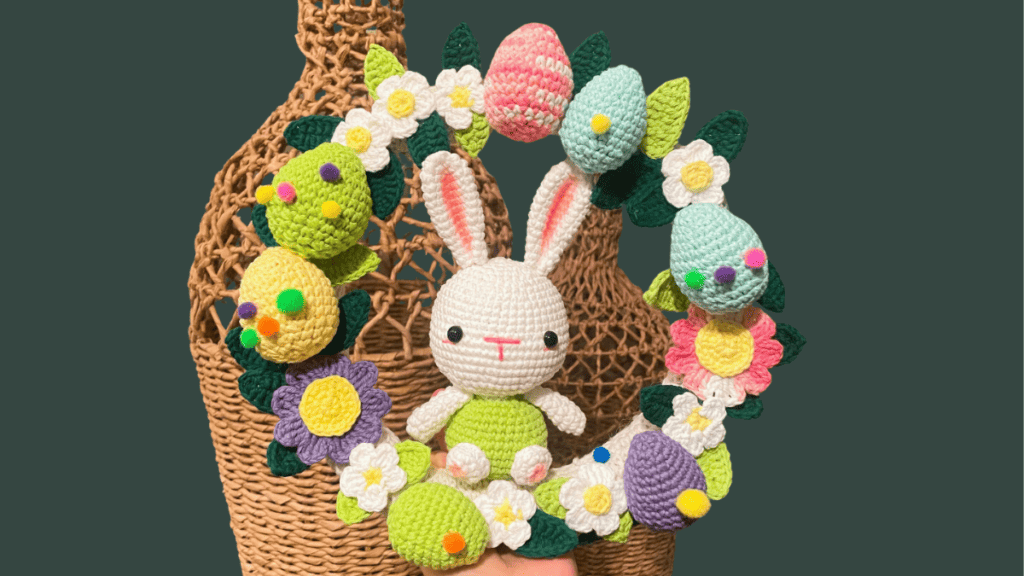 Crochet easter wreath with easter bunny in middle and flower and eggs surrounding him