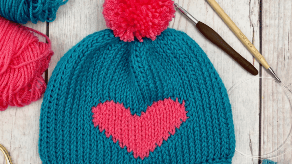 tunisian crochet hat with pink pompom and heart