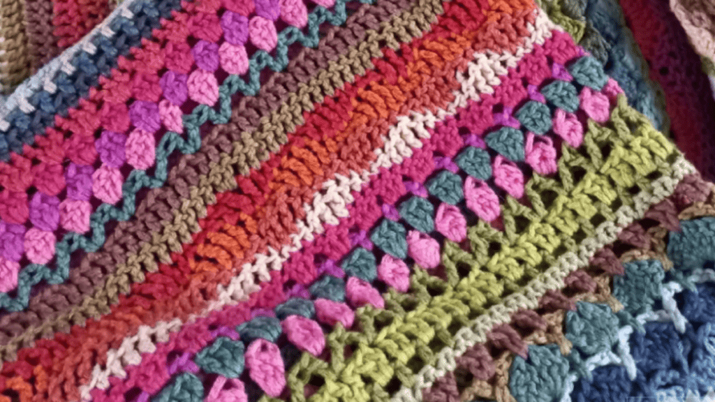 crochet blanket with brightly colored yarn