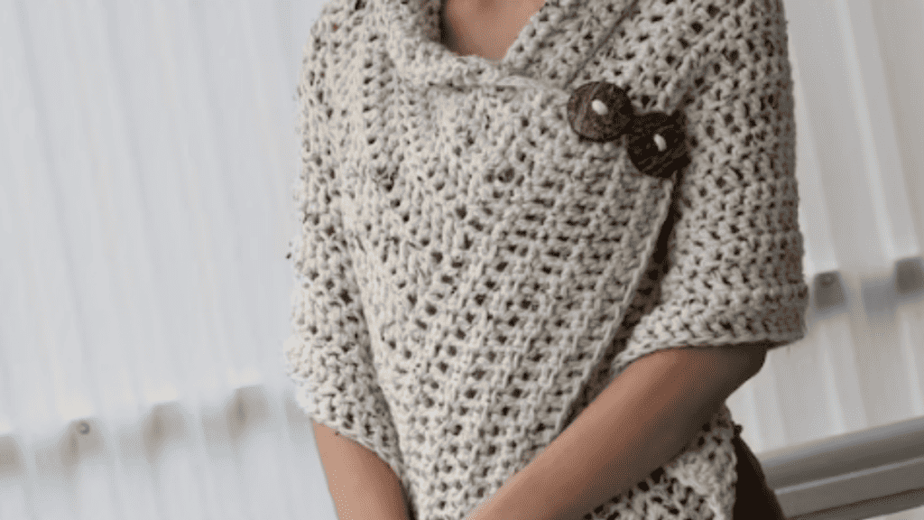 tan crochet wrap with a brown button