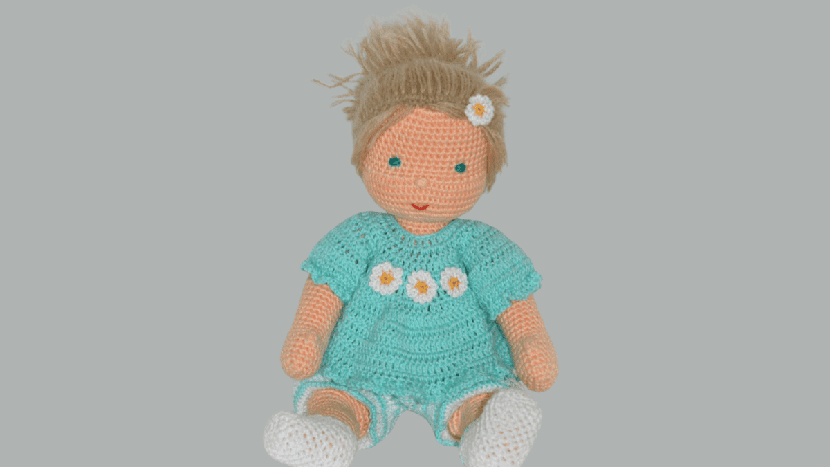 crochet doll with brown hair and green dress. part of the how to crochet a doll pdf pattern