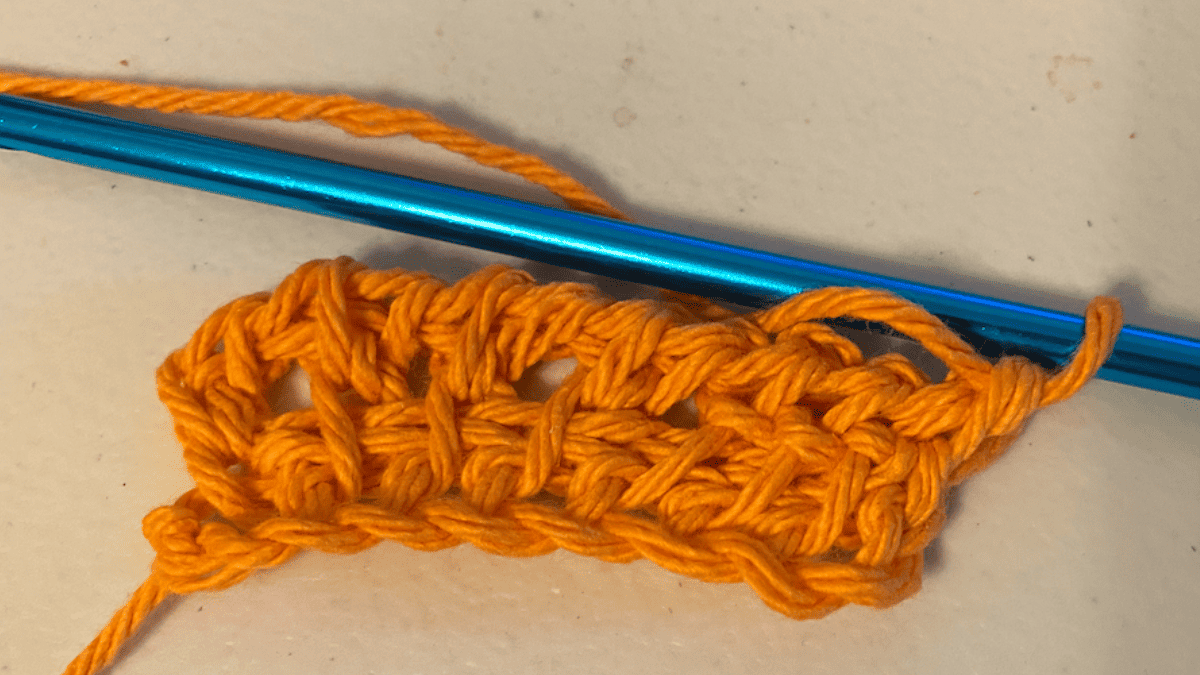 orange yarn that show a tunisian crochet purl stitch