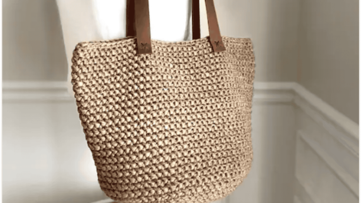 crochet market tote that is a light brown with brown handles