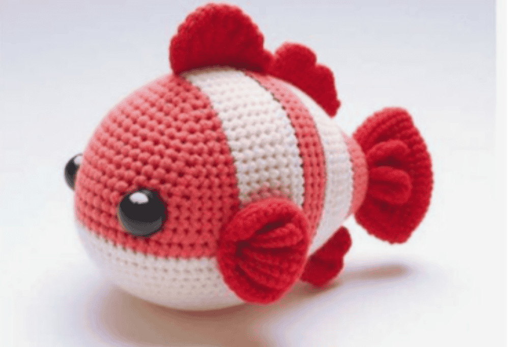 red, pink and white striped fish with black buttons