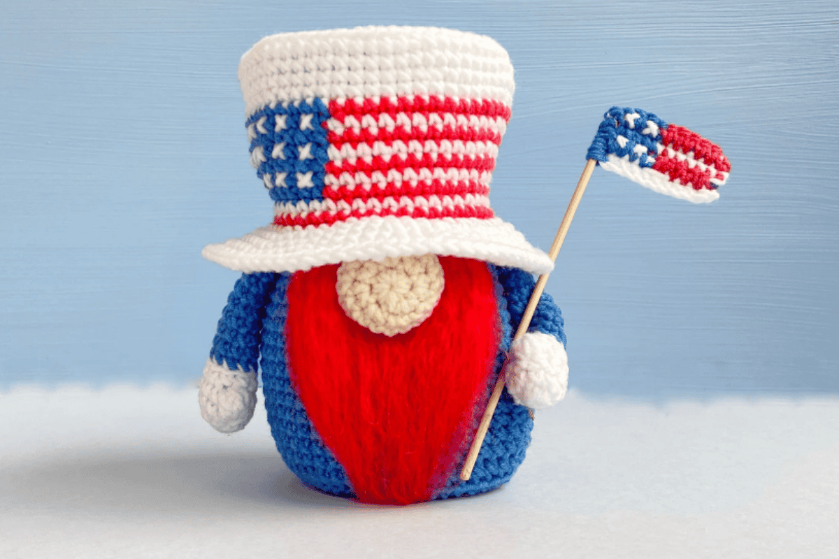 gnome with red white and blue holding a flag