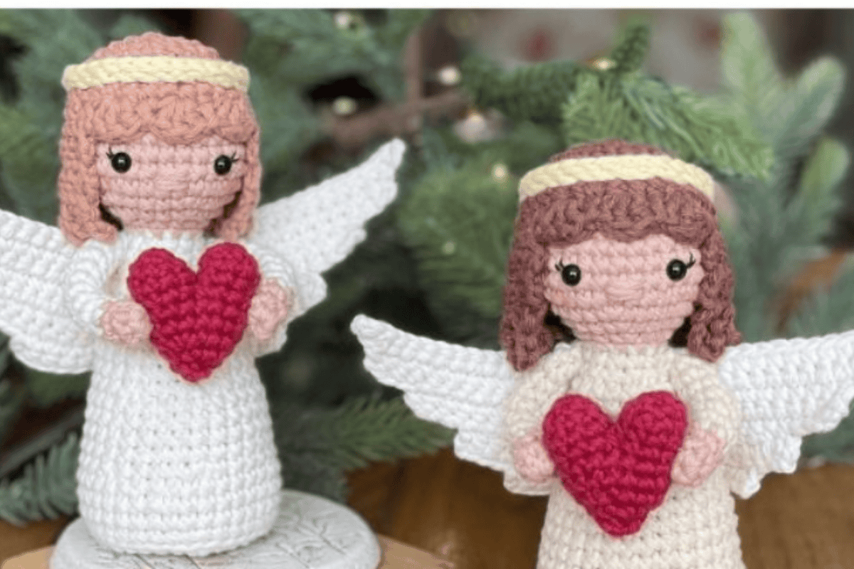 white crochet angels with brown hair and holding red heart crochet angel patterns