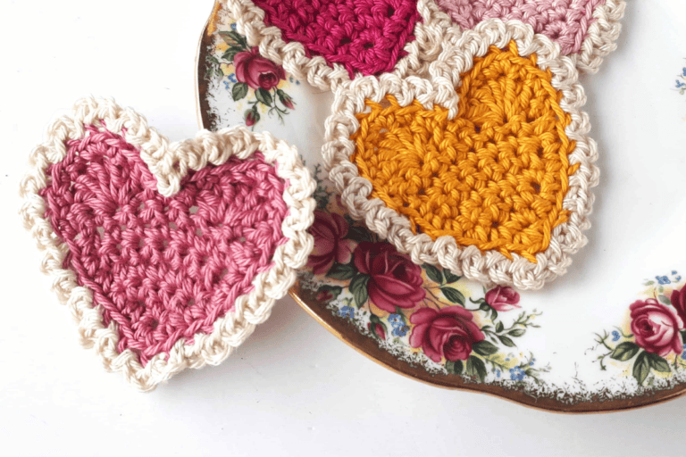 Pink and yellow hearts with cream colored yarn trimming it