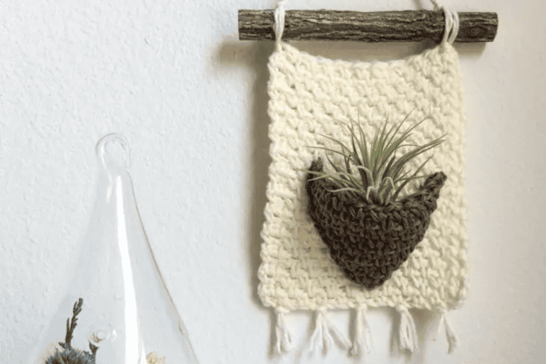 cream wall hanging with plant