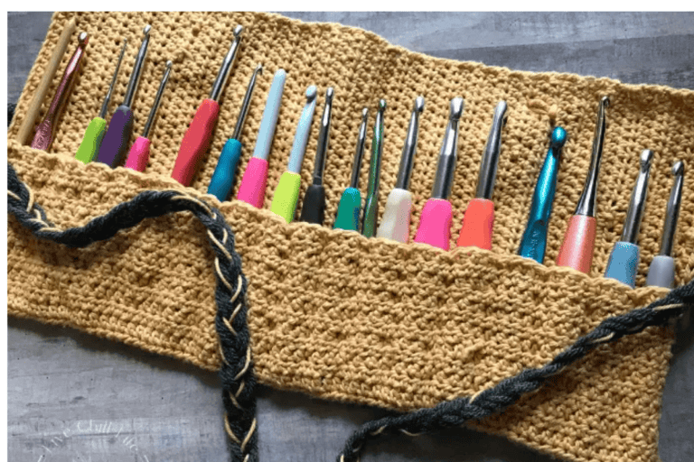 Tan colored crochet hook organizer with hooks and black stripes